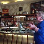 Photo of Betty Skelton in mid story in front of the counter at Jaconelli's Ice Cream Parlour, Maryhill